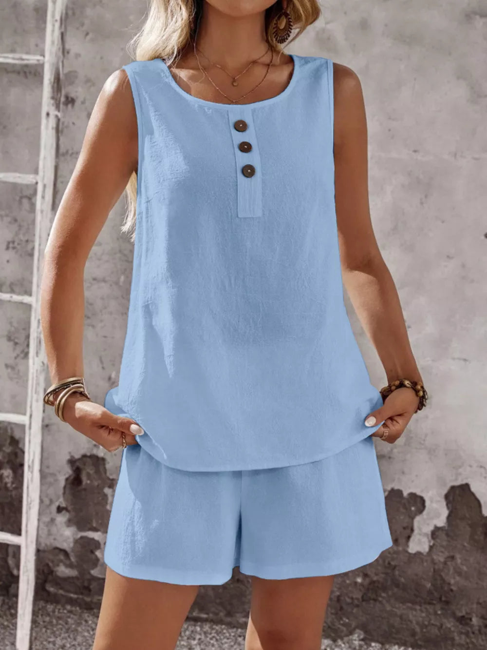 Sky blue cotton two-piece set with decorative buttons on the sleeveless top and matching shorts.