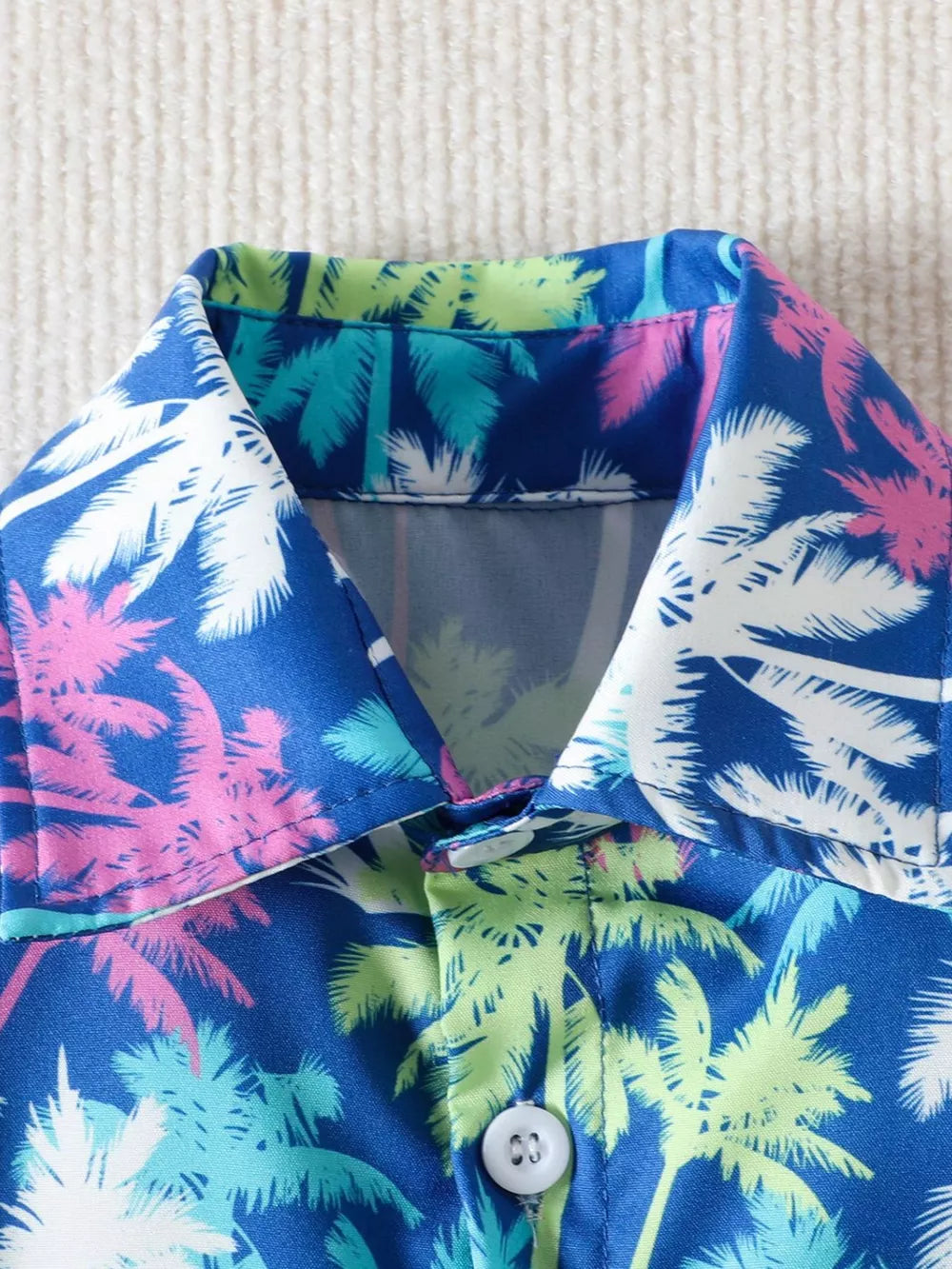 Baby shirt with multicolor palm tree print, button front, and camp collar.