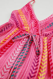 Pink chevron stripe tiered maxi dress with a tie waist and tassel detail.