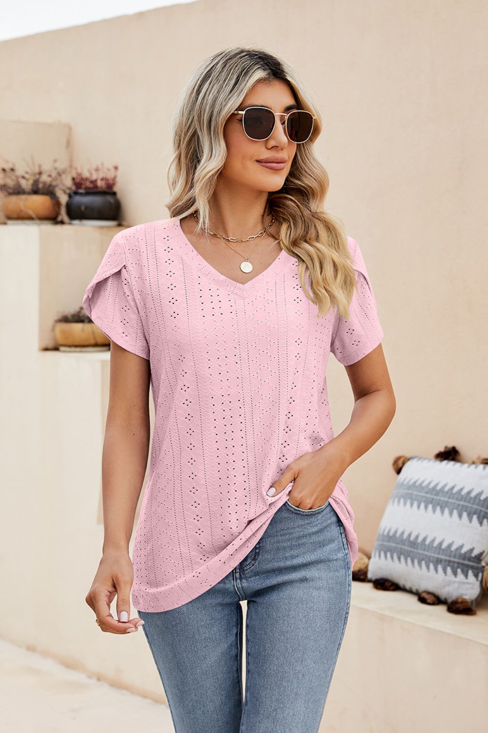 Blush pink knit top with v-neck and perforated sleeve details
