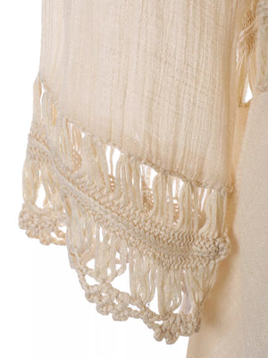 Apricot flowy cover-up with crochet trim and fringe detail.