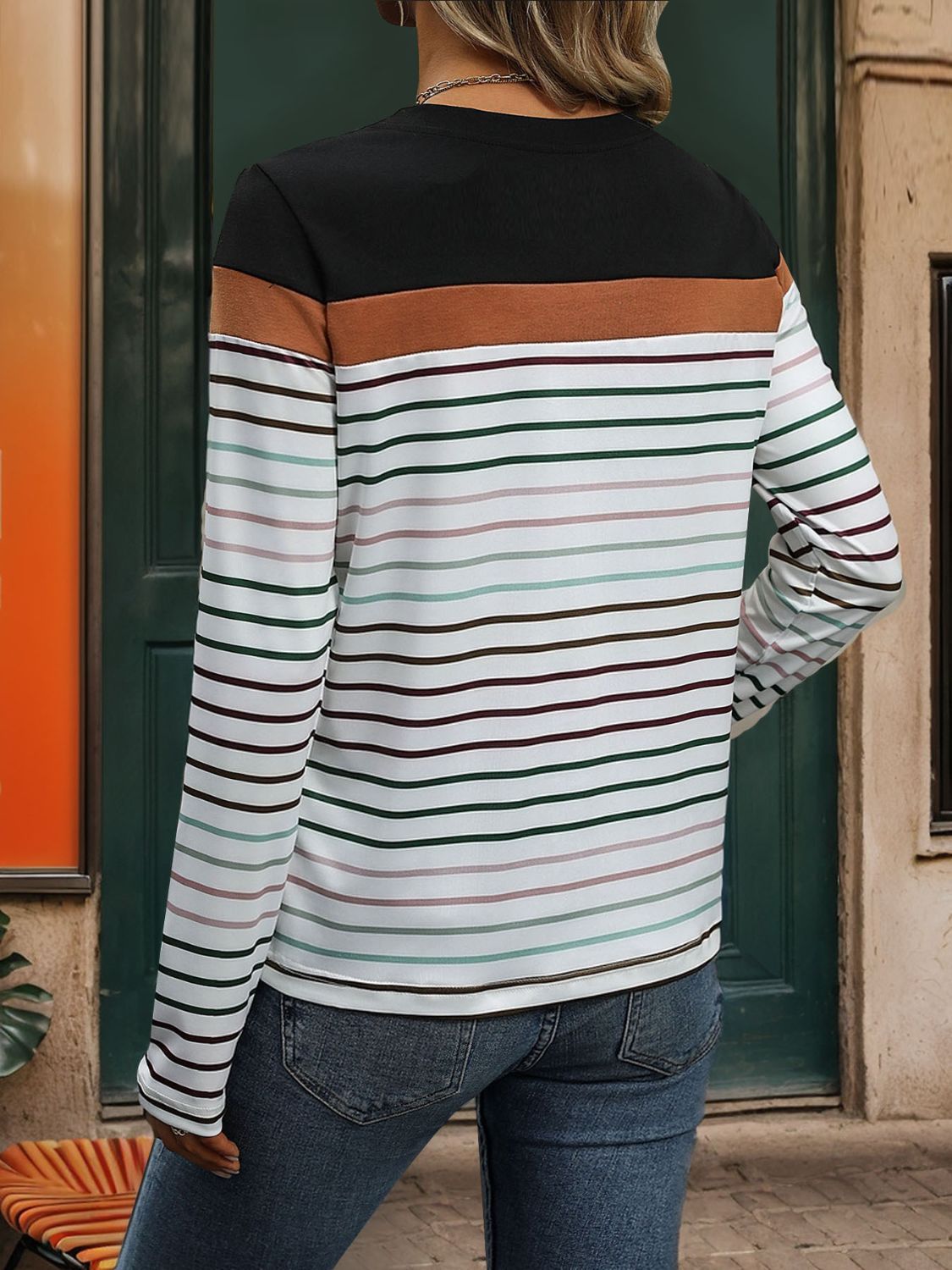 Color Block Stripe Crew Neck Top in black with multi-colored stripes and long sleeves.