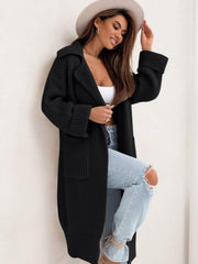 Black oversized knit lapel cardigan with pockets and cuffed sleeves.
