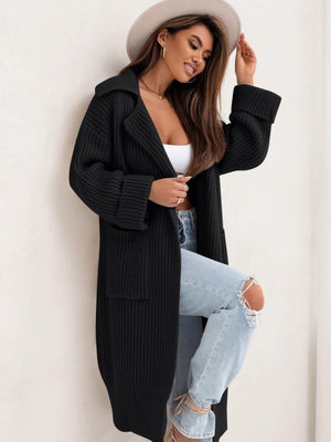 Black oversized knit lapel cardigan with pockets and cuffed sleeves.