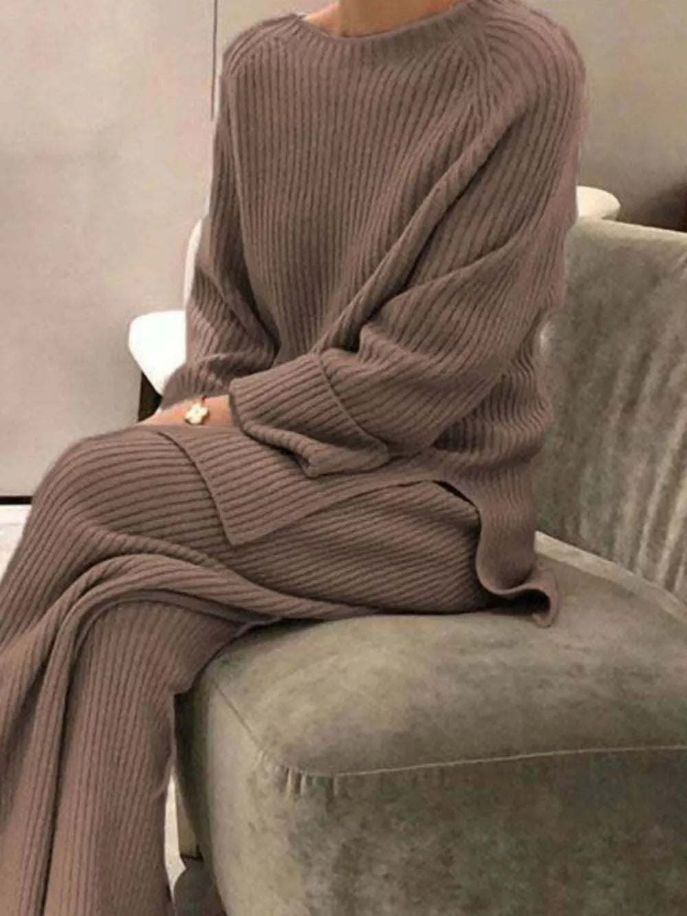 Ribbed knit two-piece sweater ensemble in beige with crewneck and wide leg pants.