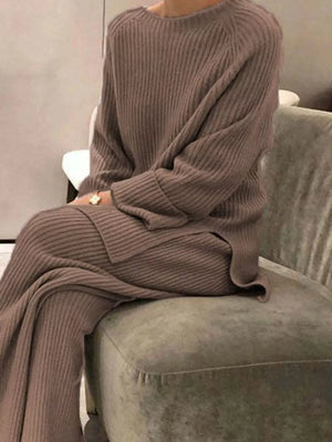 Ribbed knit two-piece sweater ensemble in beige with crewneck and wide leg pants.