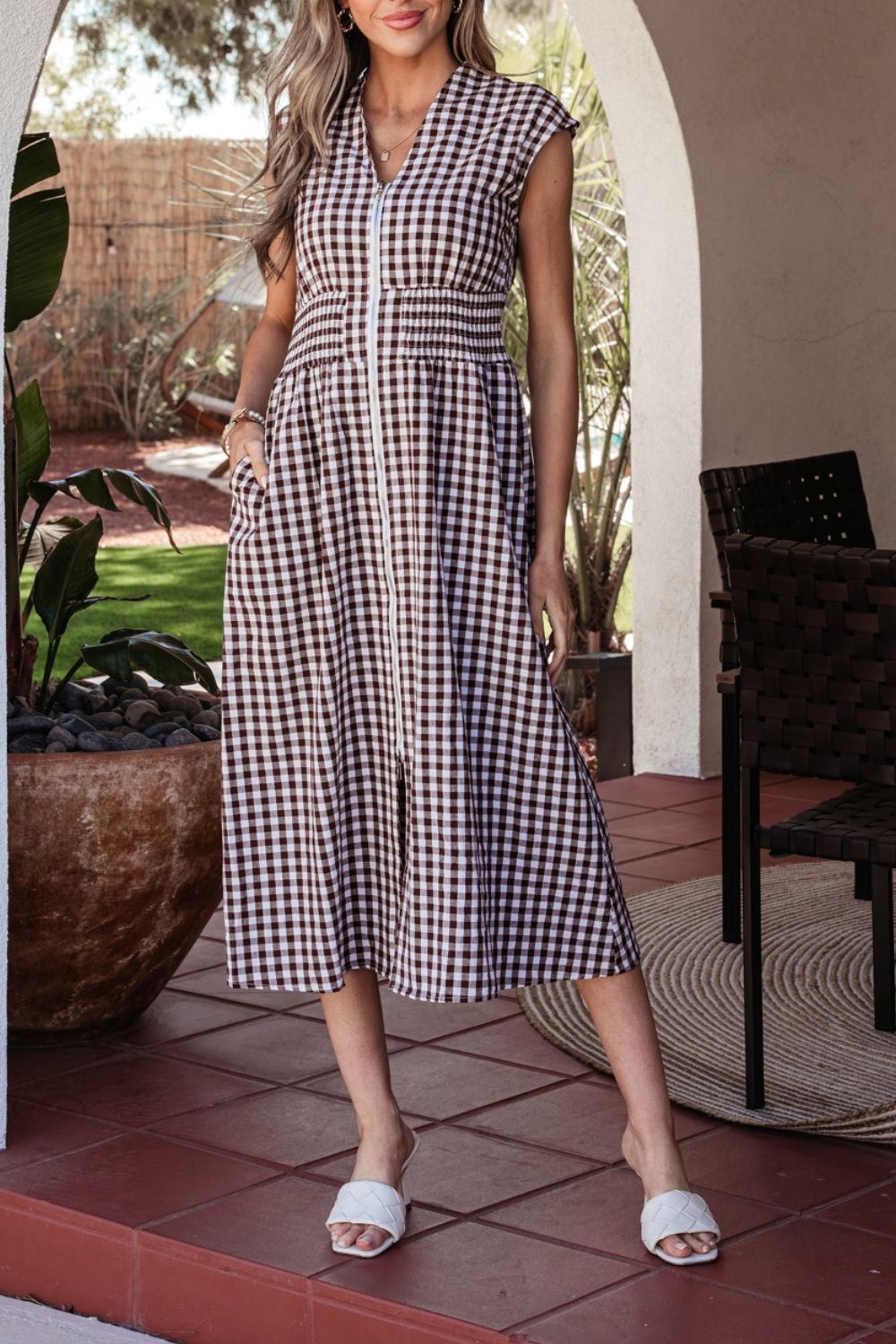 Gingham zip-front midi dress in taupe with smocked waist and cap sleeves.