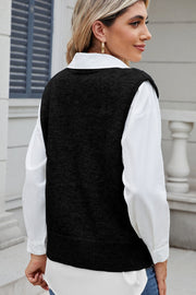 Black acrylic knit vest with shoulder detail, button front, ribbed hem