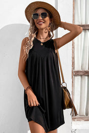 Black sleeveless trapeze dress with pleated yoke detail and V-neck