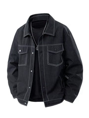 Oversized black denim trucker jacket with white contrast stitching and snap front.