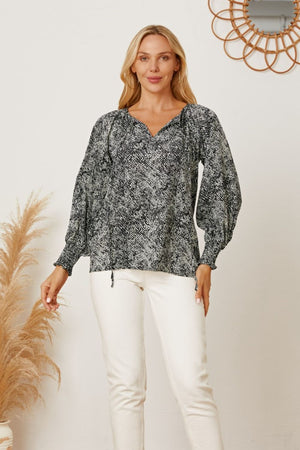 Black serpentine print blouse with V-neck and gathered sleeves.