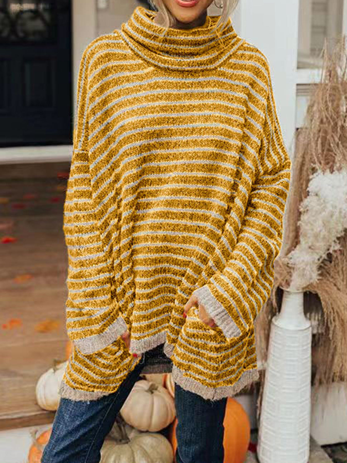 Gold striped oversized turtleneck sweater with slouch pockets and ribbed cuffs.