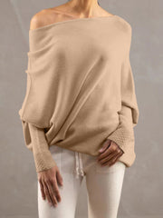 Cream off-shoulder knit sweater with textured cuffs and batwing sleeves.