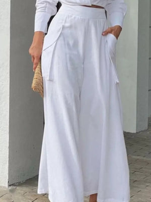 White polyester two-piece set with pocketed wide-leg pants and long sleeve shirt.