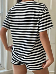 Waffle knit two-piece loungewear set in black and white stripes. Crew neck, short sleeves, and shorts.