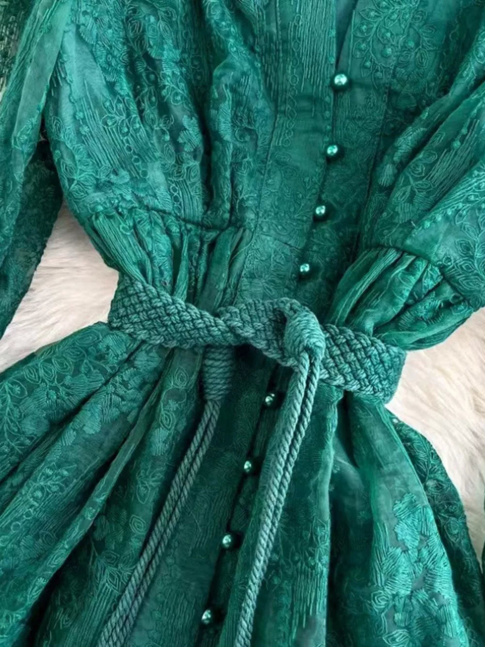 Green lace maxi dress with balloon sleeves, button-down front, and tie waist.