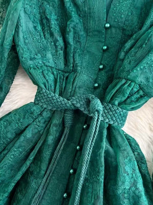 Green lace maxi dress with balloon sleeves, button-down front, and tie waist.