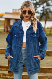 Oversized denim trucker jacket in medium blue with classic button front and chest pockets.