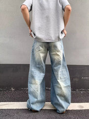 Distressed light wash denim wide-leg jeans with pocket detail.