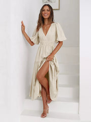 Beige midi dress with puff sleeves, V-neck, cinched waist, and tiered skirt with high slit.