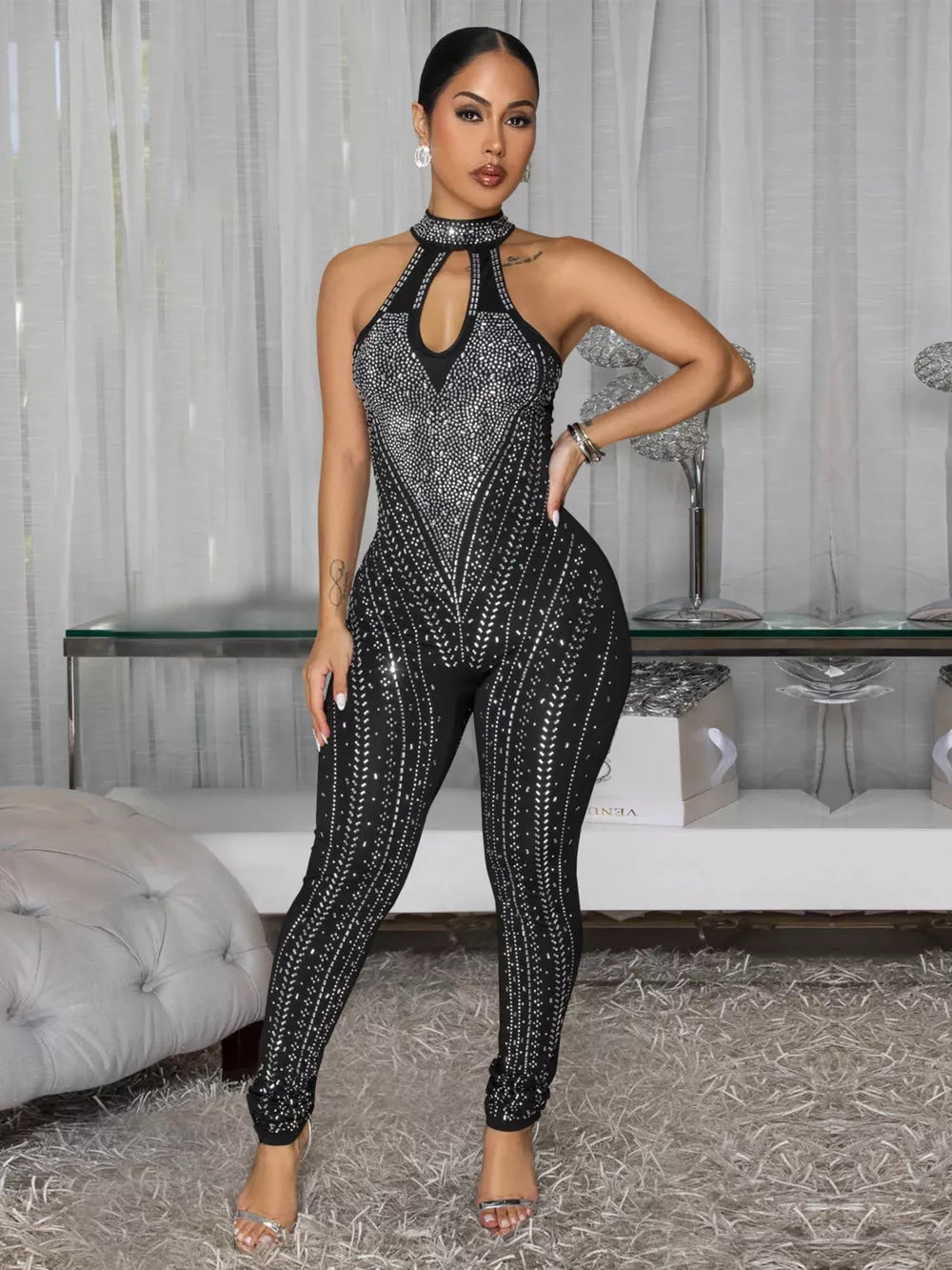 Black rhinestone halter neck romper with cutout and full length legs.