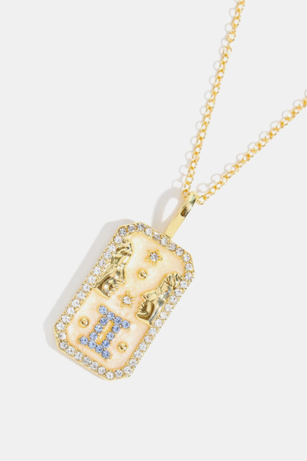 14K gold-plated Gemini zodiac crystal pendant necklace with rhinestone border and blue gem accents.
