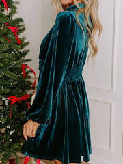 Peacock blue velvet mock neck dress with balloon sleeves and smocked waist.