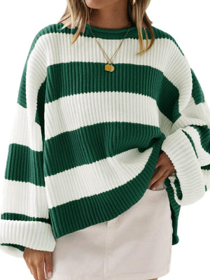 Oversized knit sweater with green and white stripes, crew neck, and dropped shoulders.