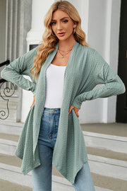 Light green textured knit cardigan with asymmetrical drape front and long sleeves.