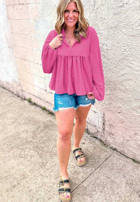 Hot pink textured blouse with gathered yoke, collar, and balloon sleeves.