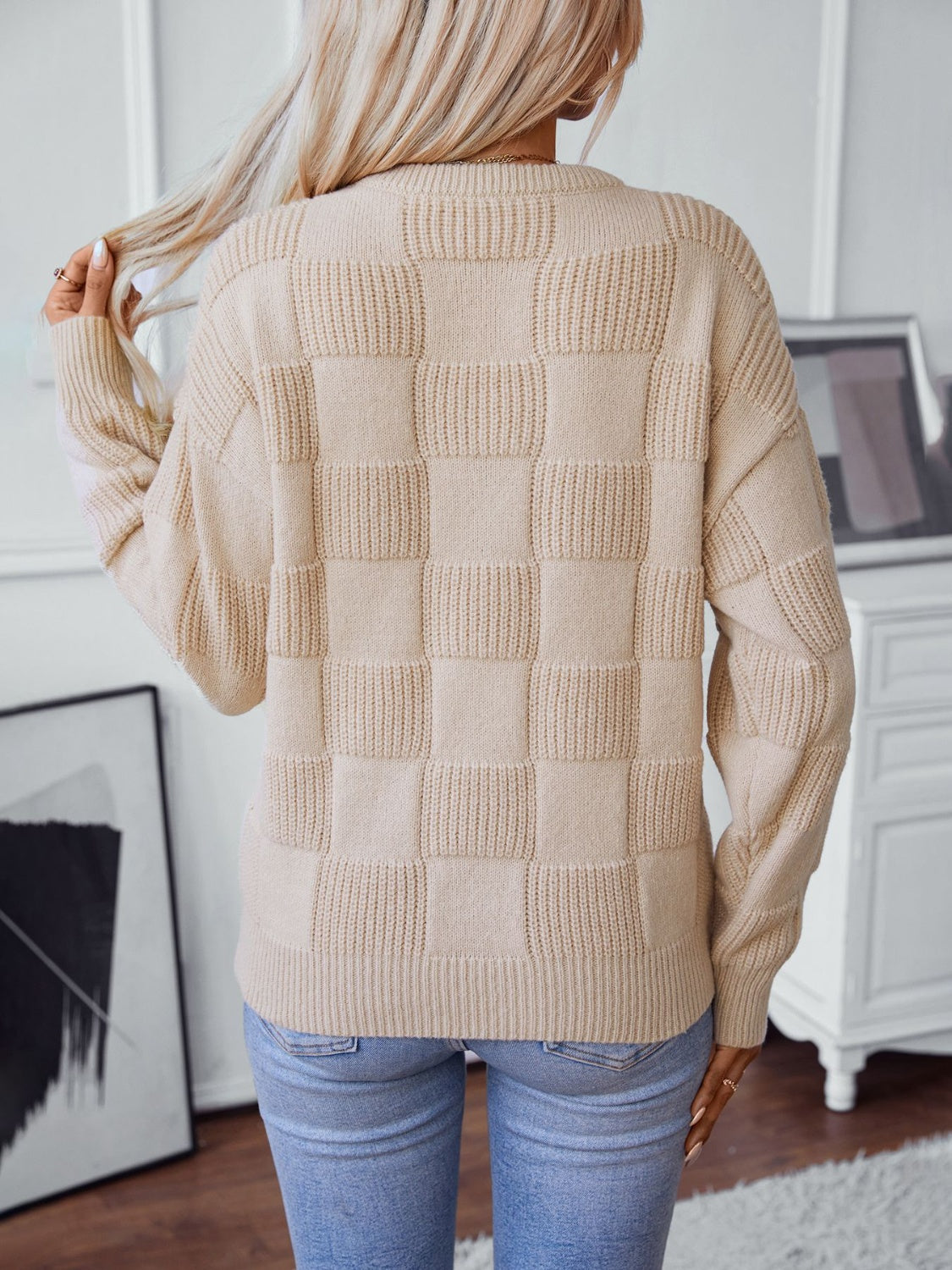 Cream textured checkerboard knit pullover sweater with ribbed details.