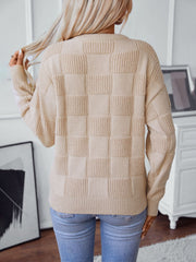 Cream textured checkerboard knit pullover sweater with ribbed details.