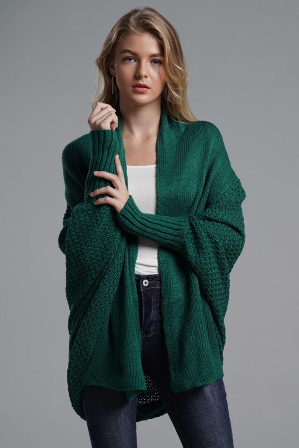 Green batwing knit cardigan with drape front and textured sleeves.