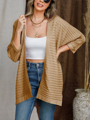 Camel ribbed sleeve cardigan with open front, styled with a white crop top and jeans.