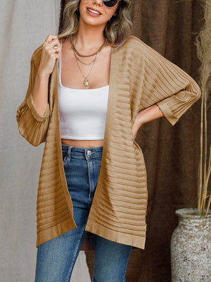 Camel ribbed sleeve cardigan with open front, styled with a white crop top and jeans.