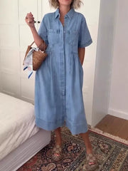 Denim midi dress with short sleeves, collared neckline, button front, and chest pockets.