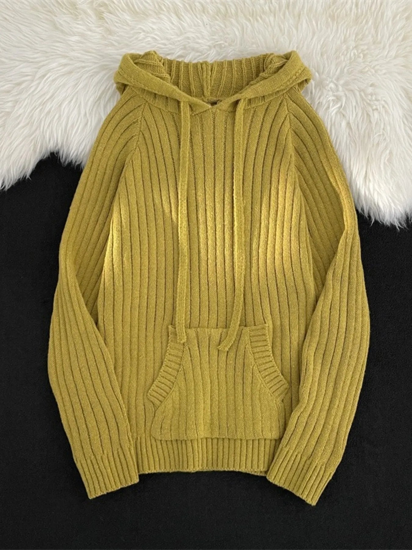 Yellow ribbed knit hooded sweater with drawstring and front pocket.