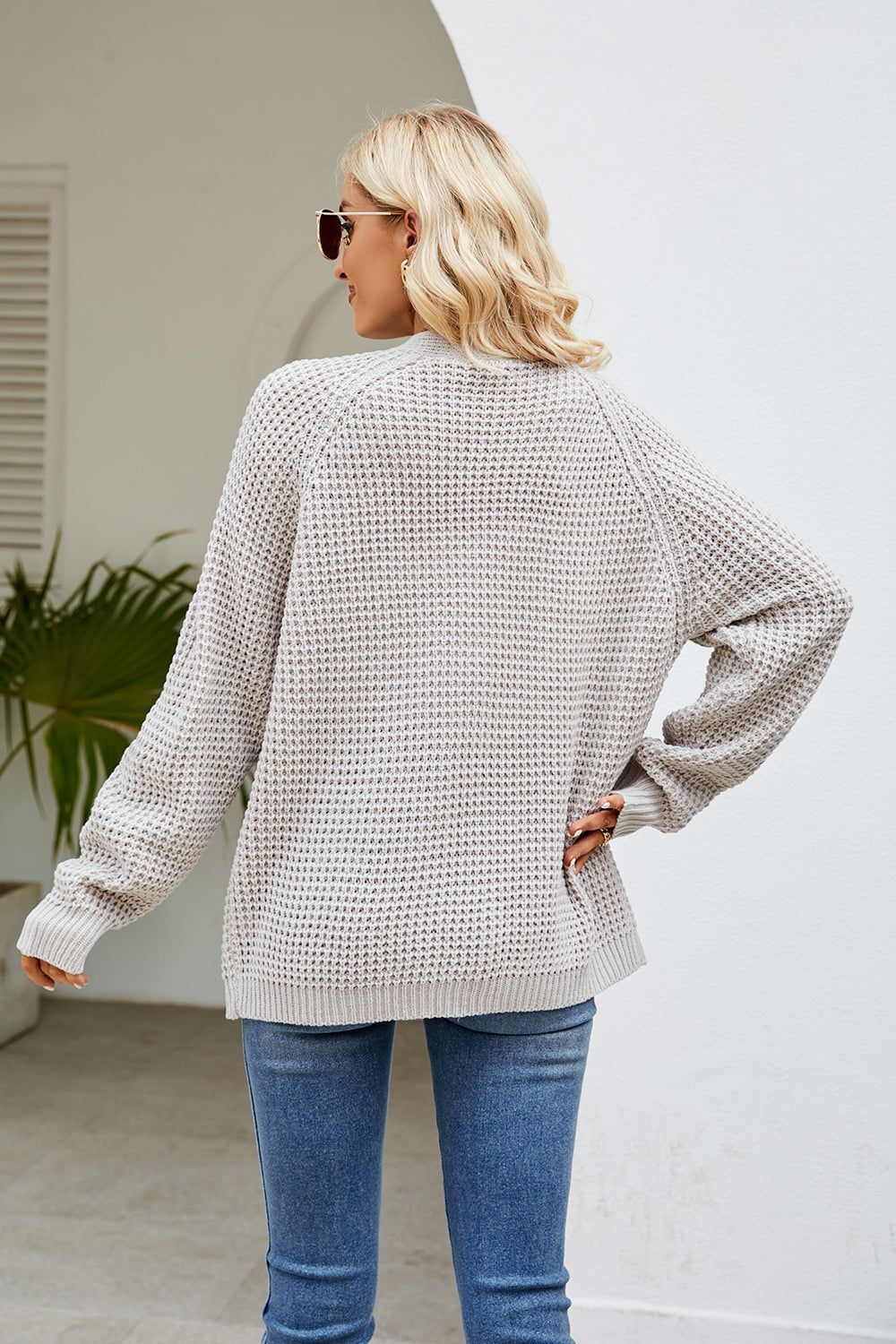 Light gray waffle knit raglan pocket cardigan with crew neckline and long sleeves.