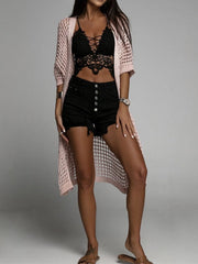 Open-knit duster cardigan in Apricot with short sleeves and a long hem, styled with a lace bralette and denim shorts.