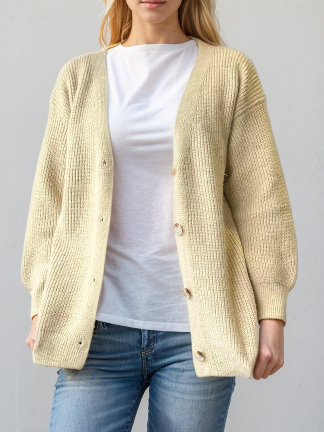 Pastel yellow ribbed knit cardigan with balloon sleeves and button front.