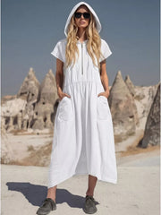 White hooded midi dress with short sleeves, zip neck, elastic waist, and large patch pockets.