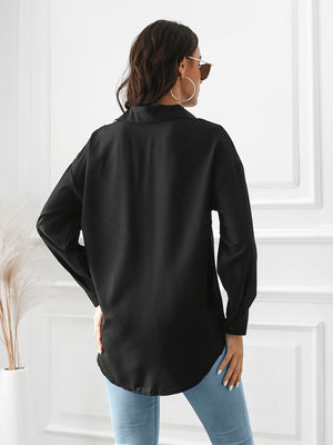 Black button-down shirt with long sleeves and a curved hem.