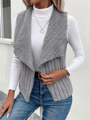 Gray textured teddy collarless vest with ribbed knit detail and open front.