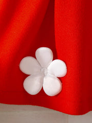 Red knit baby outfit with white floral applique detail.