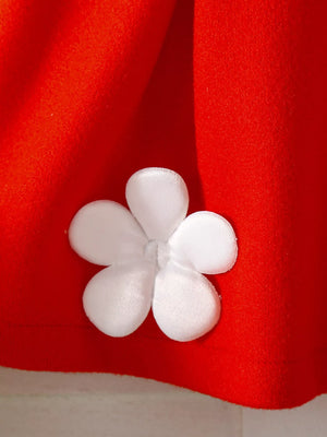 Red knit baby outfit with white floral applique detail.