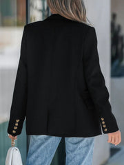 Black double-breasted blazer with gold buttons on cuffs and a sculpted fit.