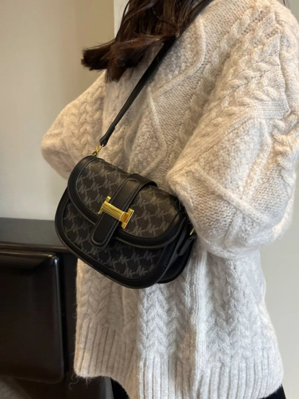 Black monogram flap crossbody bag with gold hardware detail