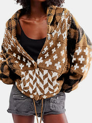 Geometric patchwork knit cardigan in brown with white and black patterns, featuring a buttoned front and shawl collar.