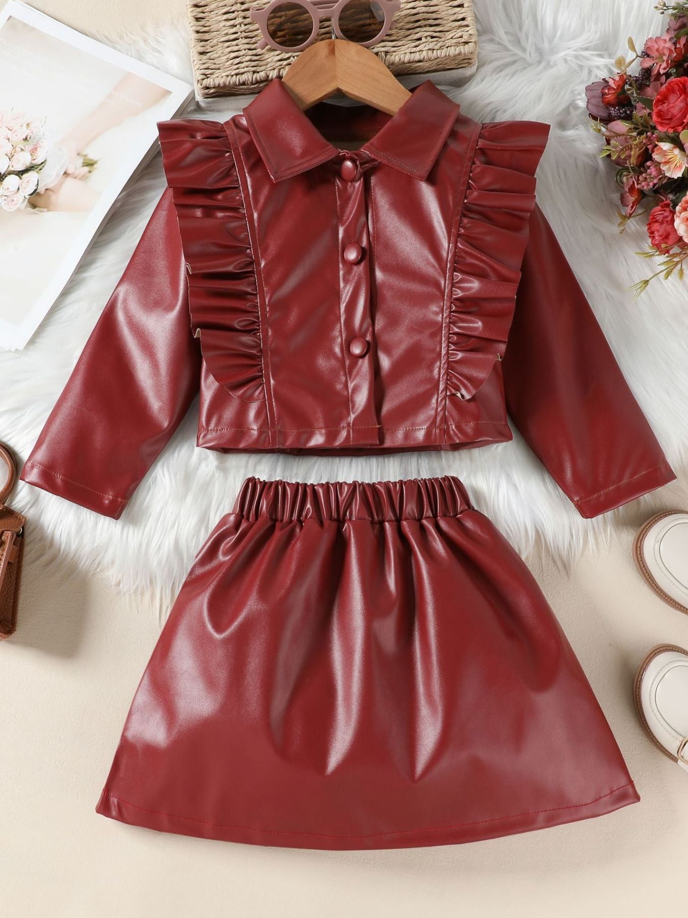 Wine red faux leather toddler set with ruffled collared jacket and elastic waist skirt.
