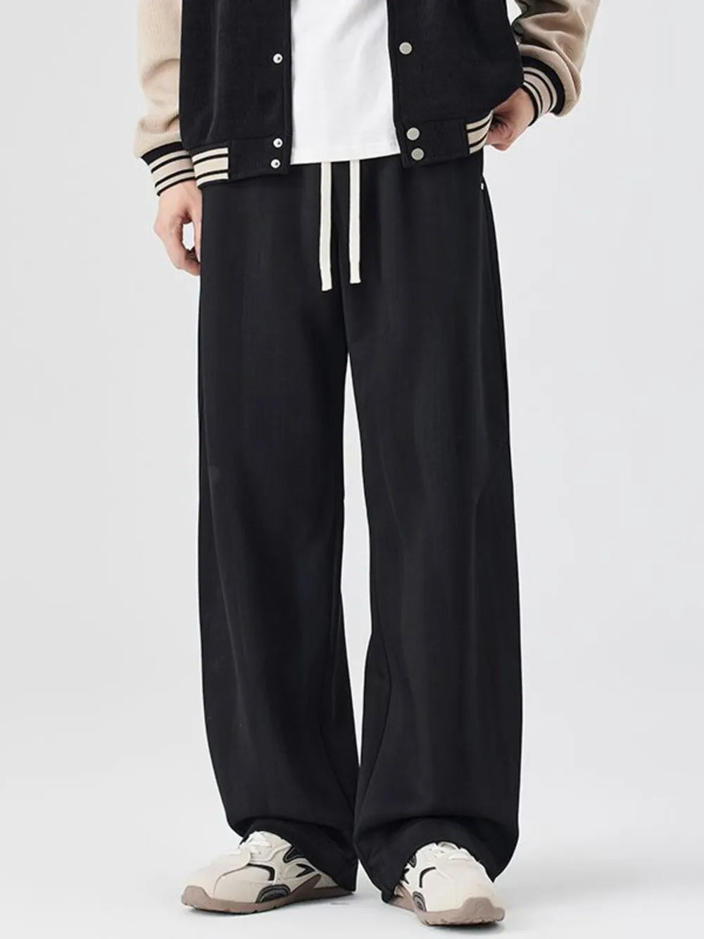 Black jogger sweatpants with white drawstring and a relaxed fit.